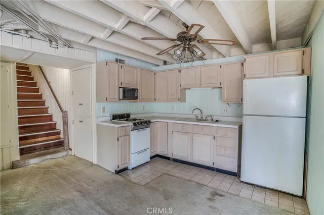 a kitchen with cabinets and white appliances