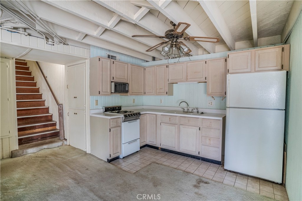 2736 Cuesta Road Santa Barbara, CA 93105 - Photo 14 of 50 a kitchen with cabinets and white appliances