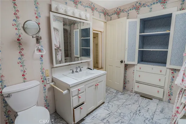 a bathroom with a sink toilet vanity and tub