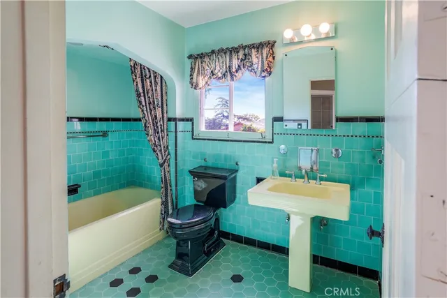 a bathroom with a sink toilet and a bathtub