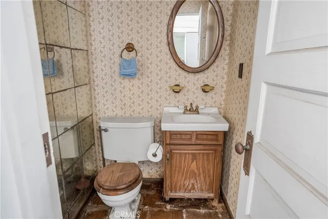 a bathroom with a sink toilet and mirror