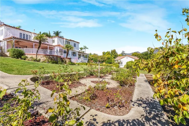 a view of a garden with a house