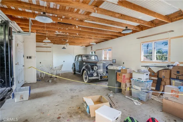a front view of a house with a yard and potted plants