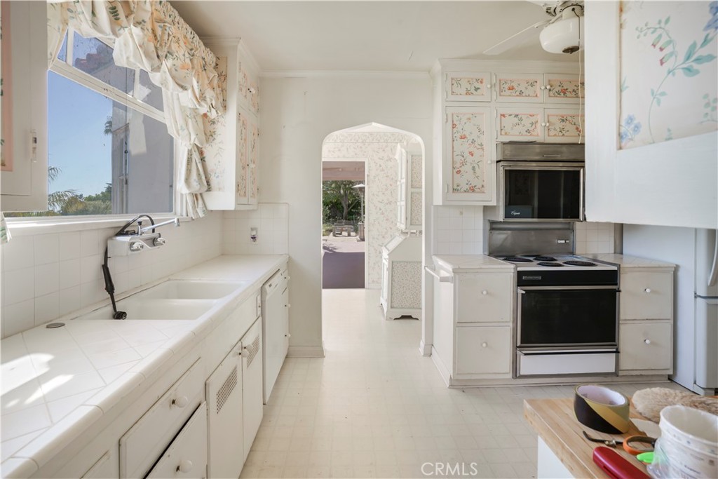 2736 Cuesta Road Santa Barbara, CA 93105 - Photo 6 of 50 a kitchen with a sink stove and cabinets