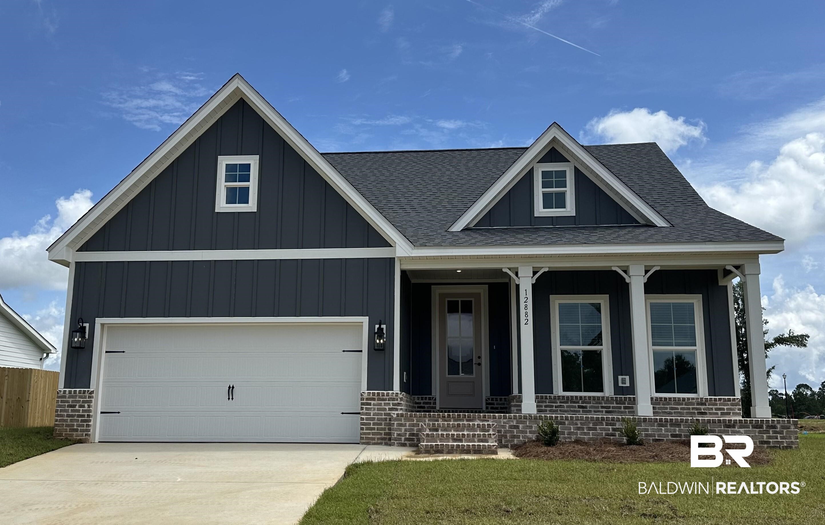 12882 Flanagan Street Elberta, AL 36530 - Photo 1 of 15 View of front of house featuring covered porch, board and batten siding, and roof with shingles