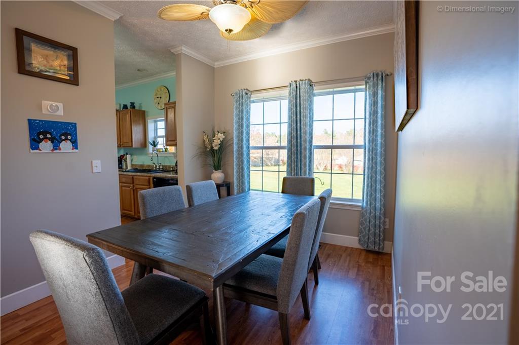 1117 North Ridge Road Hendersonville, NC 28792 - Photo 11 of 35 a view of a dining room with furniture window and wooden floor