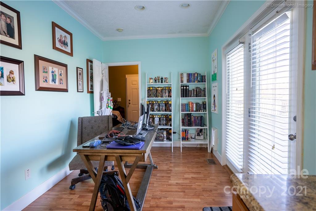 1117 North Ridge Road Hendersonville, NC 28792 - Photo 14 of 35 a living room with furniture and a book shelf