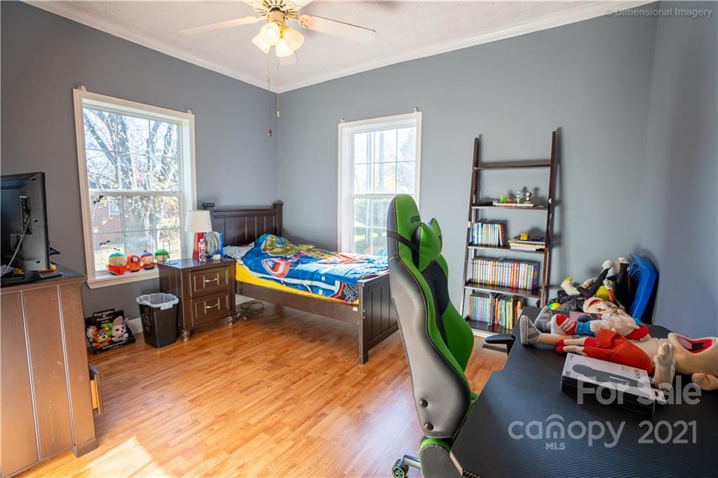 1117 North Ridge Road Hendersonville, NC 28792 - Photo 20 of 35 a living room with furniture toys and a book shelf