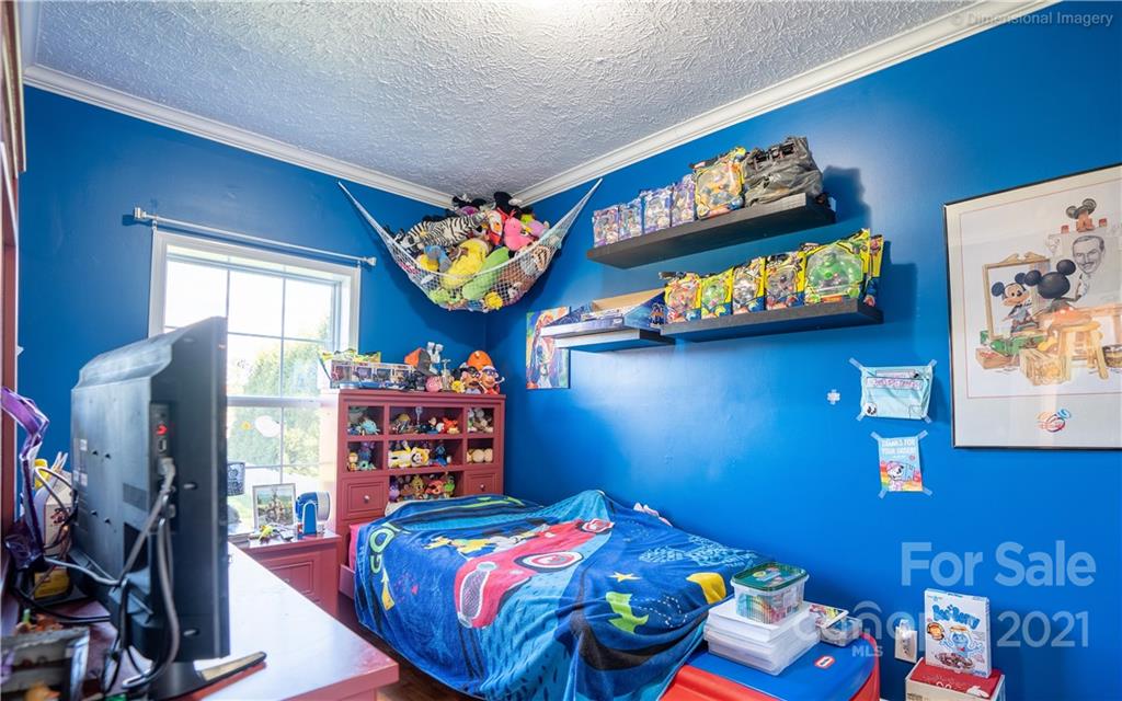 1117 North Ridge Road Hendersonville, NC 28792 - Photo 22 of 35 a bedroom with a bed and a tv in it
