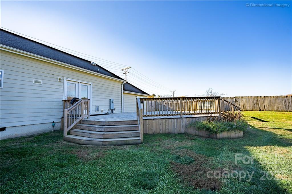 1117 North Ridge Road Hendersonville, NC 28792 - Photo 25 of 35 a view of a backyard with stairs plants and wooden fence