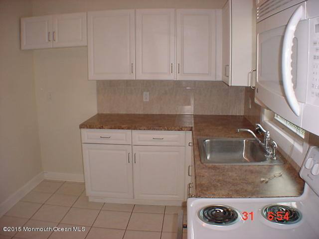 356 Drum Point Road Brick, NJ 08723 - Photo 14 of 31 a kitchen with a sink and cabinets