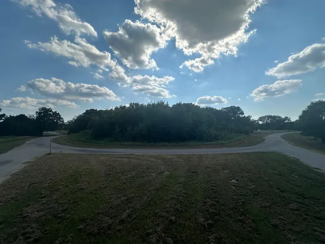 a view of a building in the middle of a yard