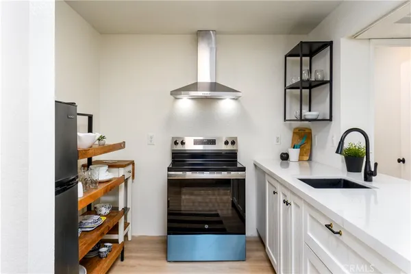 a kitchen with stainless steel appliances granite countertop a stove and a sink