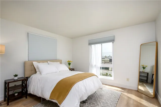 a bed sitting in a bedroom next to a window