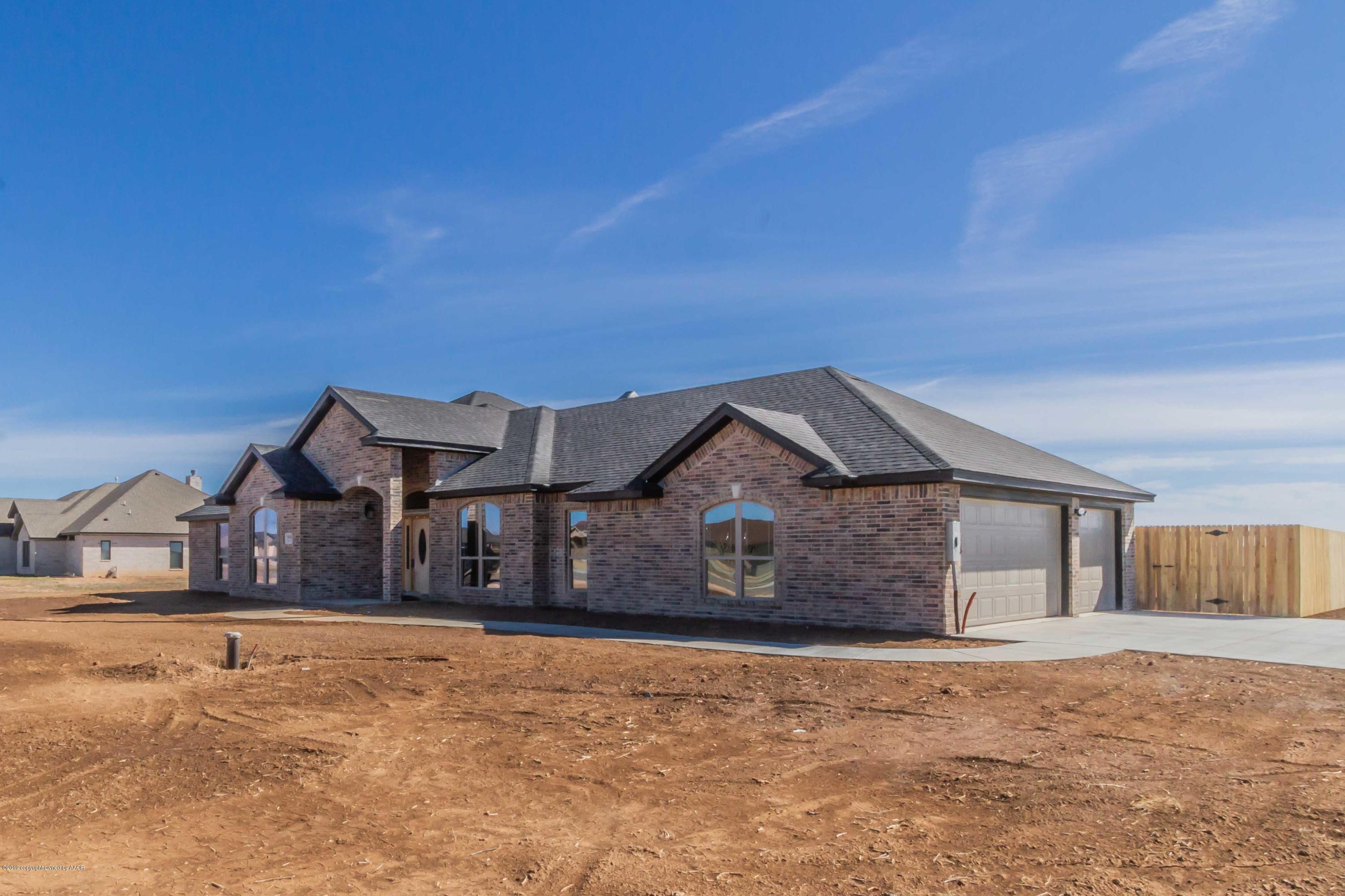 9801 Help Lane Amarillo, TX 79119 - Photo 3 of 46 a front view of a house with a yard