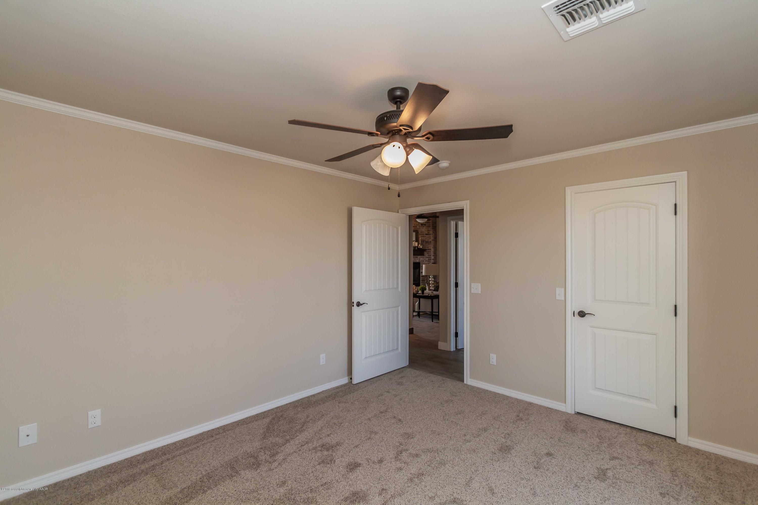 9801 Help Lane Amarillo, TX 79119 - Photo 33 of 46 an empty room with a ceiling fan and a window