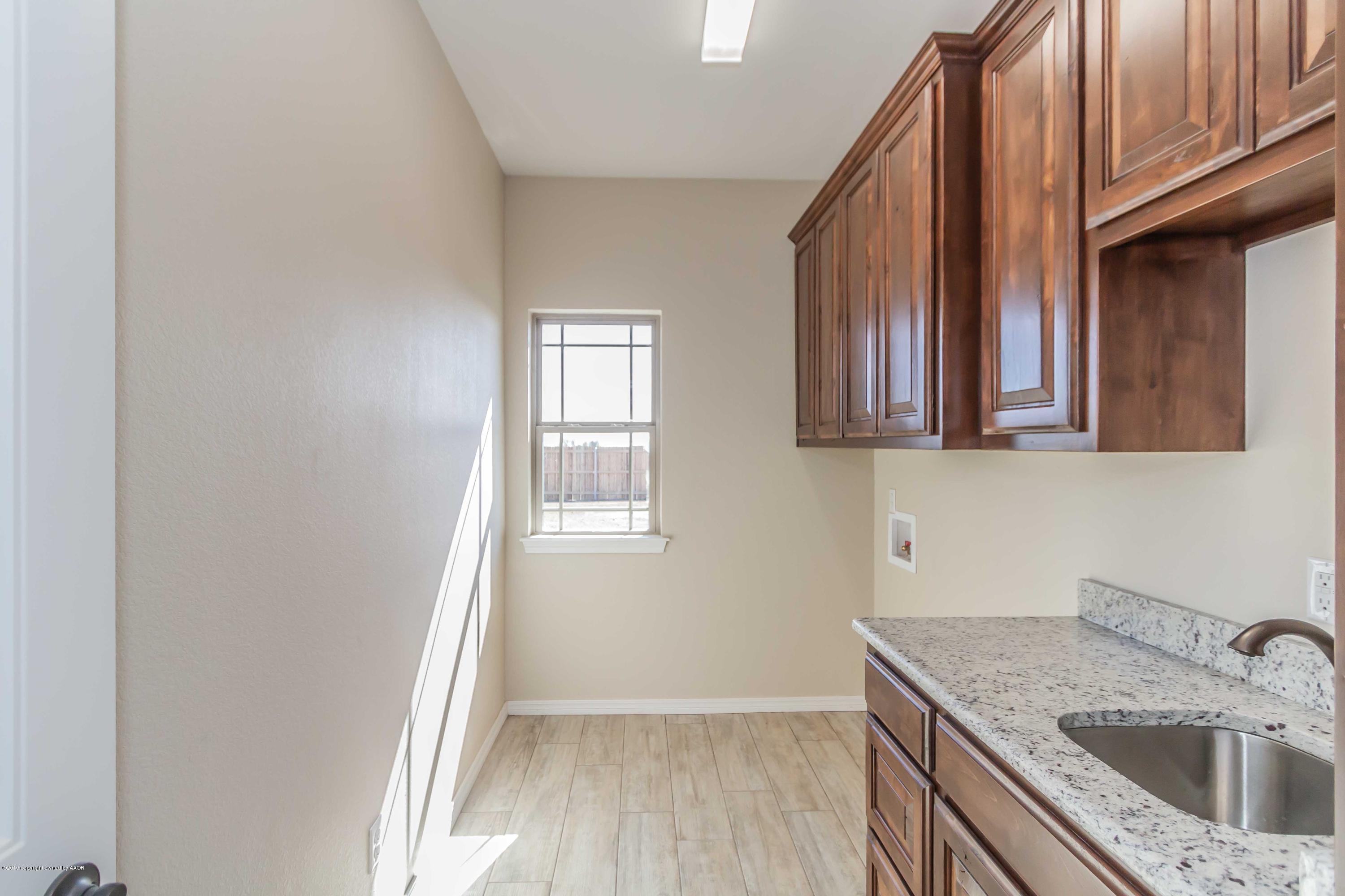 9801 Help Lane Amarillo, TX 79119 - Photo 42 of 46 a kitchen with a sink a stove and cabinets