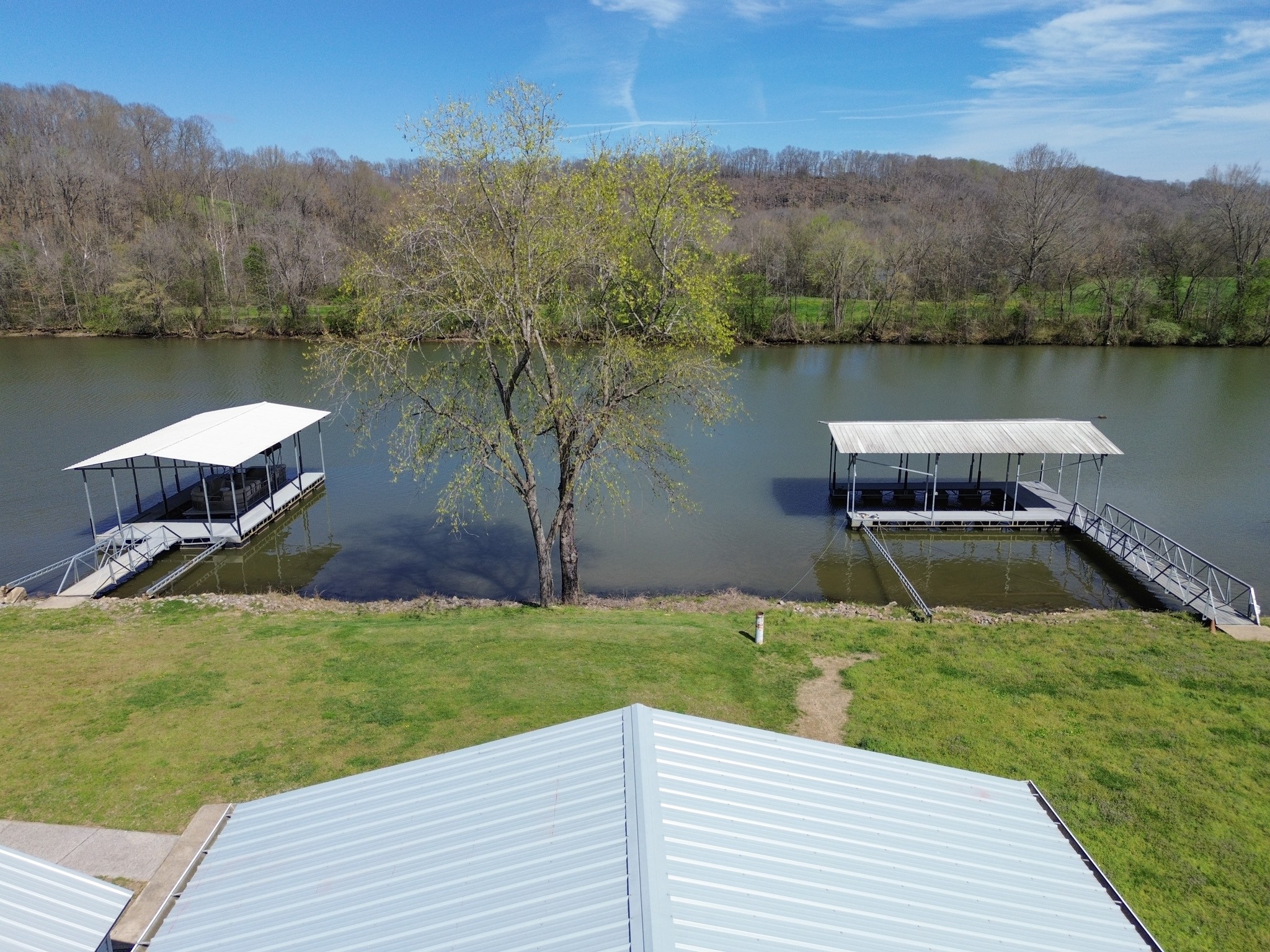 1467 Chapmansboro Road Chapmansboro, TN 37035 - Photo 12 of 13 a view of a lake with a yard and large trees