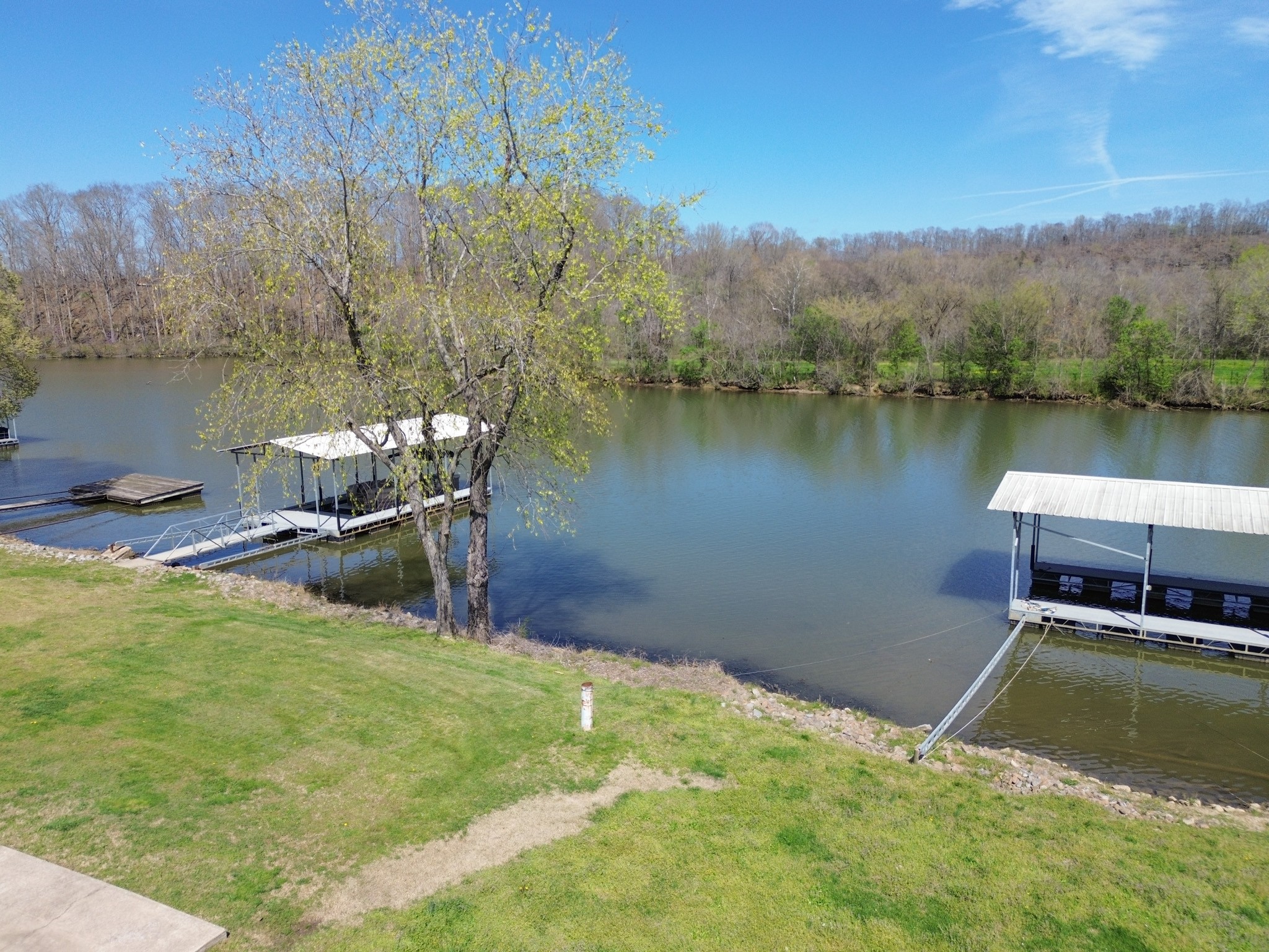 1467 Chapmansboro Road Chapmansboro, TN 37035 - Photo 8 of 13 a view of a lake with a yard and large trees