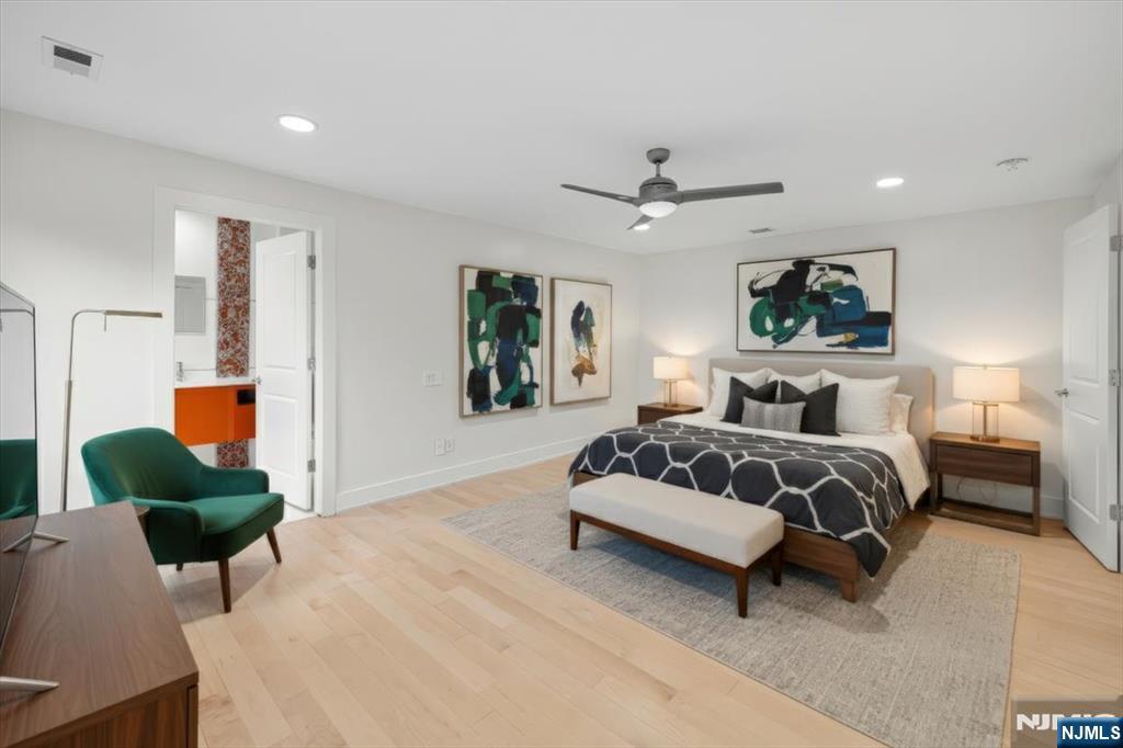 827 Alden Road Paramus, NJ 07652 - Photo 20 of 43 a spacious bedroom with a bed a window and a couch