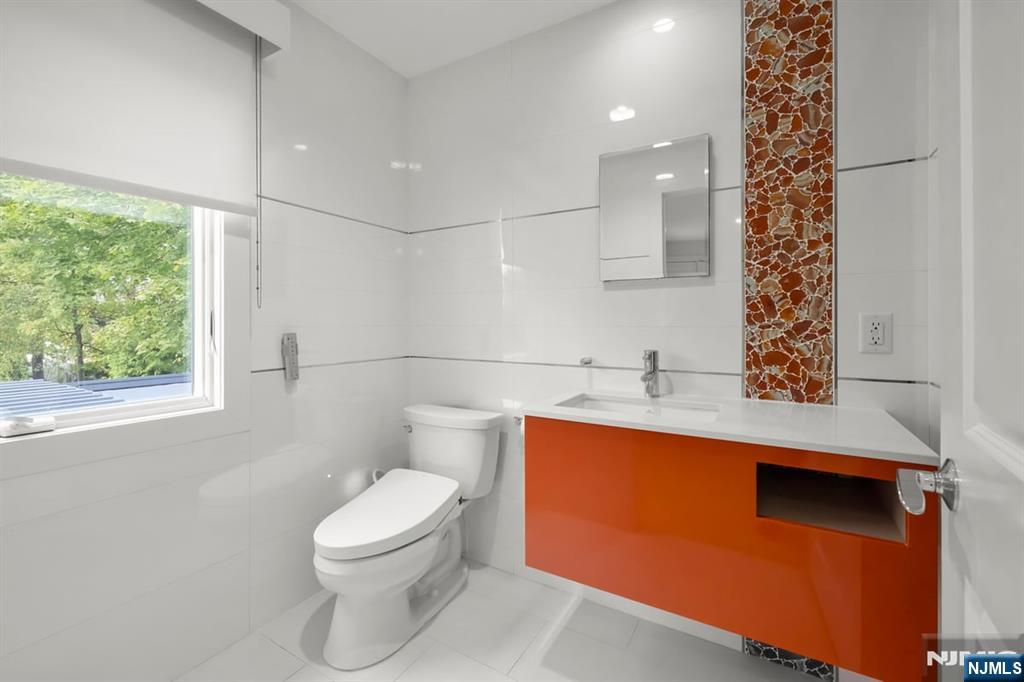 827 Alden Road Paramus, NJ 07652 - Photo 21 of 43 a bathroom with a toilet a sink and a window