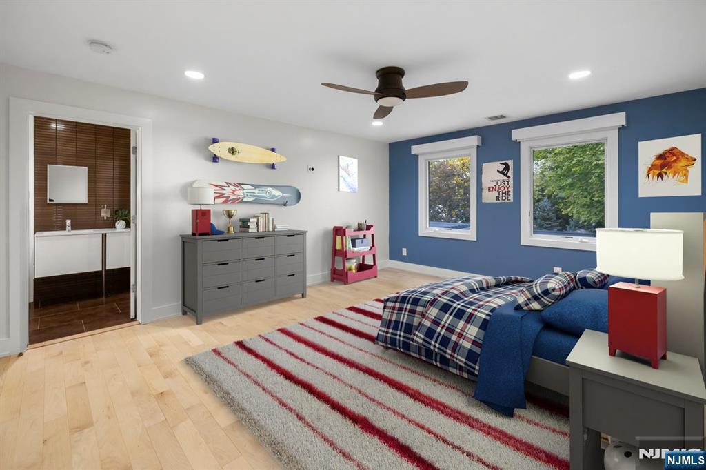 827 Alden Road Paramus, NJ 07652 - Photo 23 of 43 a bedroom with a bed and wooden floor
