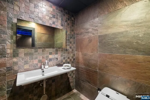 a bathroom with a sink mirror and toilet