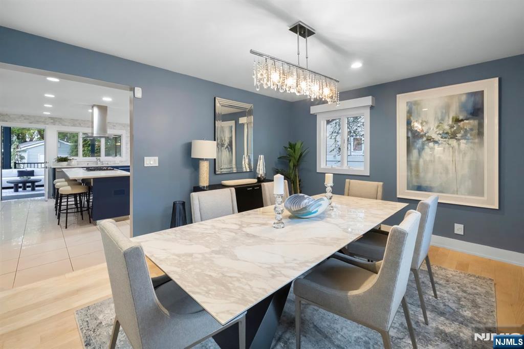 827 Alden Road Paramus, NJ 07652 - Photo 8 of 43 a view of a dining room with furniture a chandelier and wooden floor