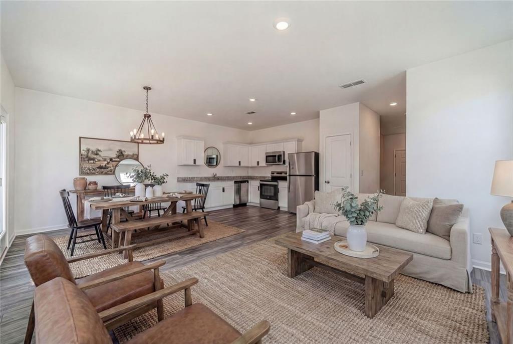 29 Padley Drive Winder, GA 30680 - Photo 3 of 25 a living room with furniture kitchen view and a chandelier