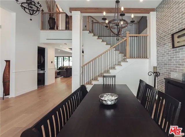 a view of a dining room with furniture wooden floor and chandelier