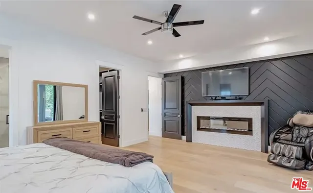 a bedroom with a bed and a fireplace