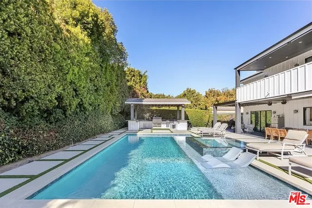 a view of a patio with couches and table and chairs and potted plants