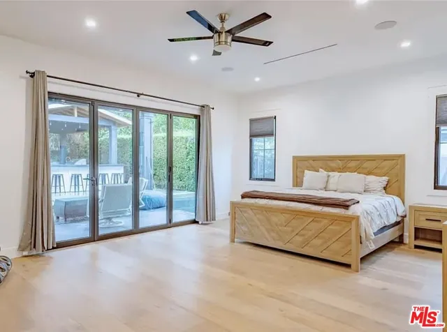 a spacious bedroom with a large bed and a large window