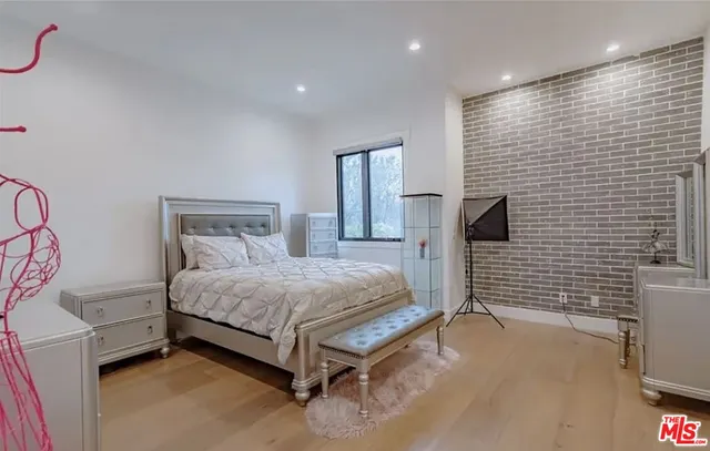 a bedroom with a bed and a flat screen tv