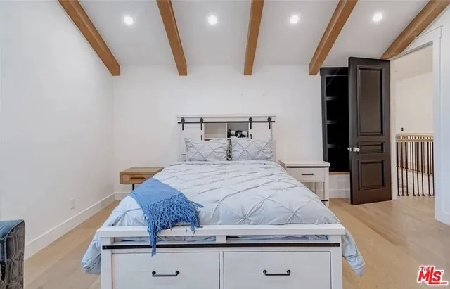 a bedroom with a bed and walk in closet