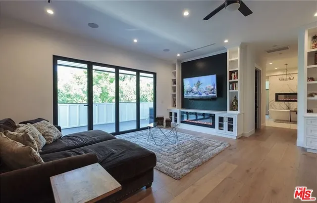 a large bedroom with a bed and glass walk in closet