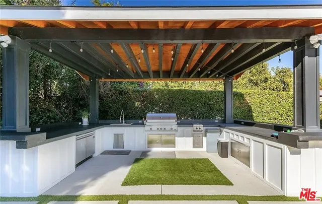 a view of a patio with table and chairs a barbeque with wooden floor