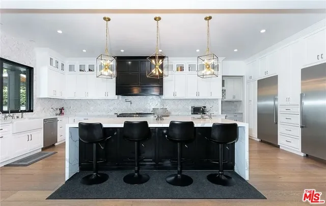 a large kitchen with a table and chairs