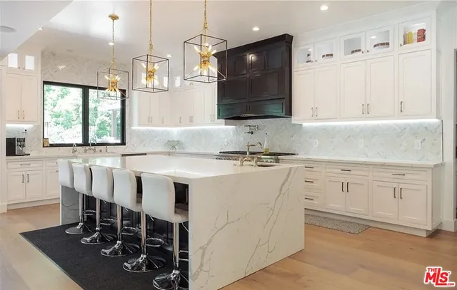 a kitchen with granite countertop a sink cabinets and window