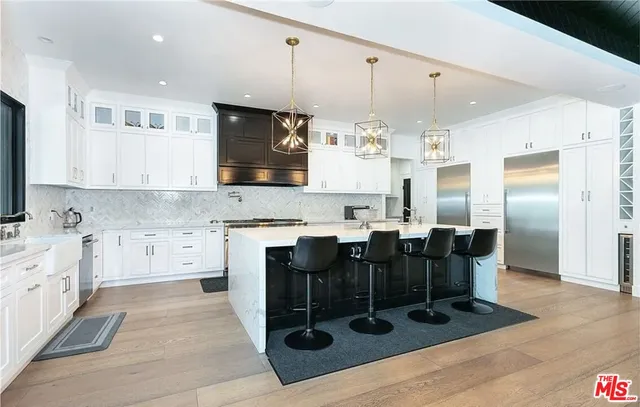 a large kitchen with lots of counter space and stainless steel appliances