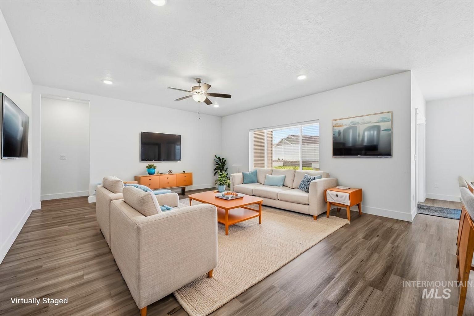 148 Homesteaders Street Middleton, ID 83644 - Photo 15 of 45 Living area with dark wood finished floors, a ceiling fan, recessed lighting, and a textured ceiling