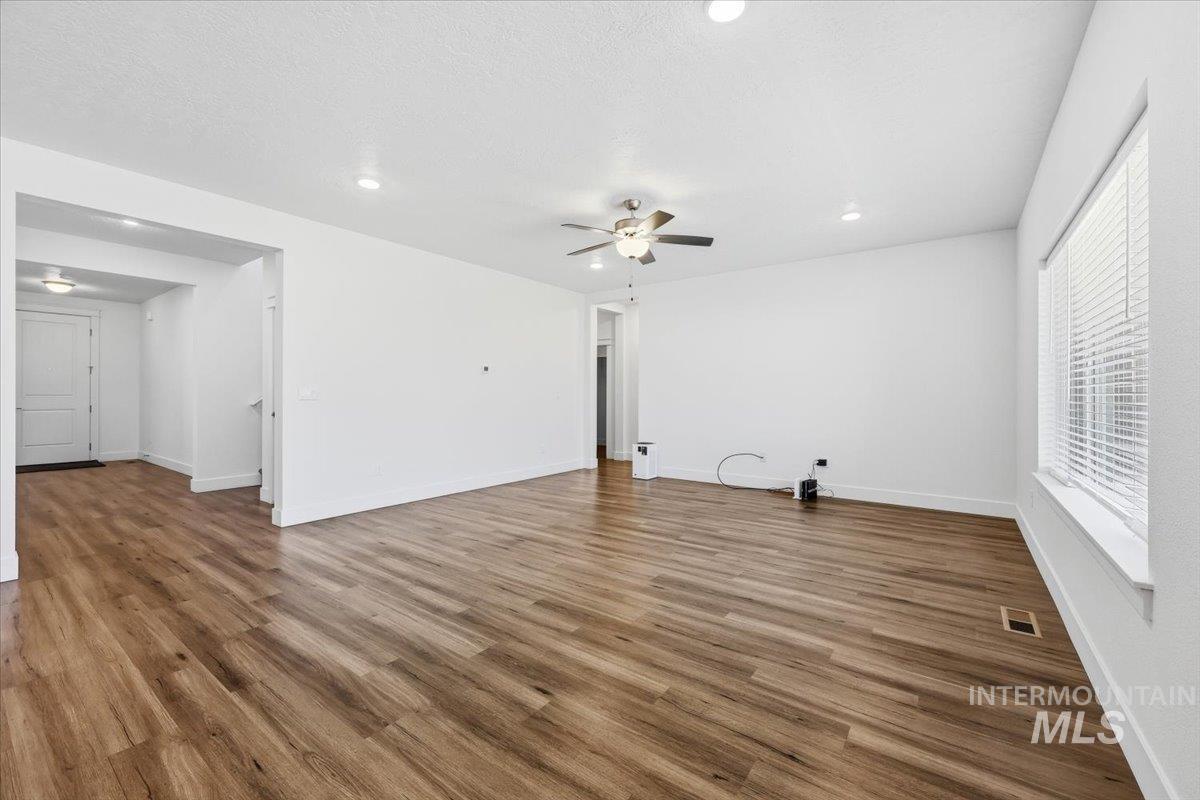 148 Homesteaders Street Middleton, ID 83644 - Photo 16 of 45 Unfurnished living room with a ceiling fan, dark wood-style flooring, and recessed lighting