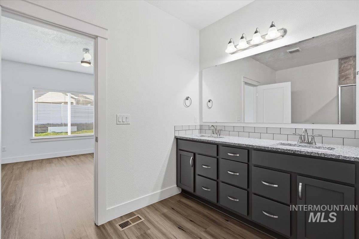 148 Homesteaders Street Middleton, ID 83644 - Photo 23 of 45 Full bathroom with double vanity and light wood-style floors