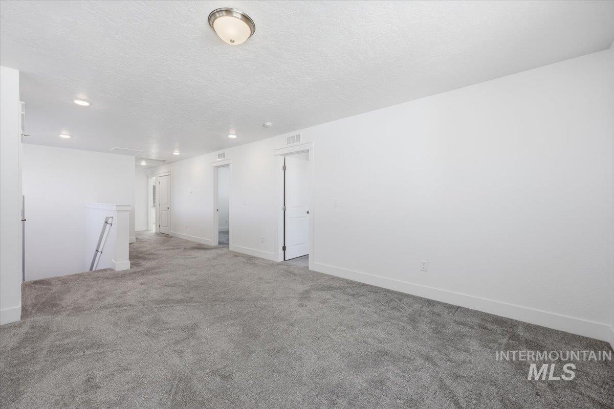 148 Homesteaders Street Middleton, ID 83644 - Photo 27 of 45 Empty room with carpet flooring and a textured ceiling