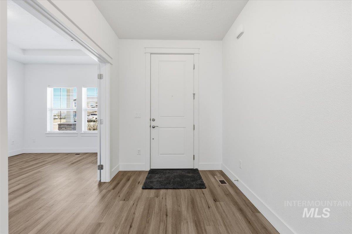 148 Homesteaders Street Middleton, ID 83644 - Photo 3 of 45 Entryway featuring light wood-style flooring and a textured ceiling