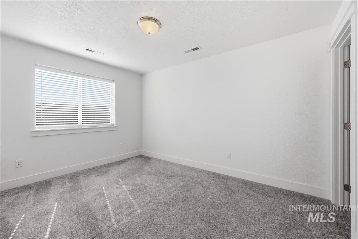 148 Homesteaders Street Middleton, ID 83644 - Photo 33 of 45 Spare room with carpet floors and a textured ceiling