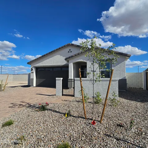 a view of a house with a wooden fence