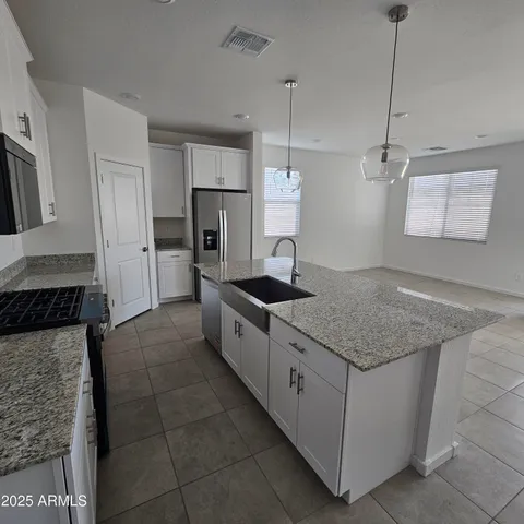 a kitchen with a stove sink and refrigerator