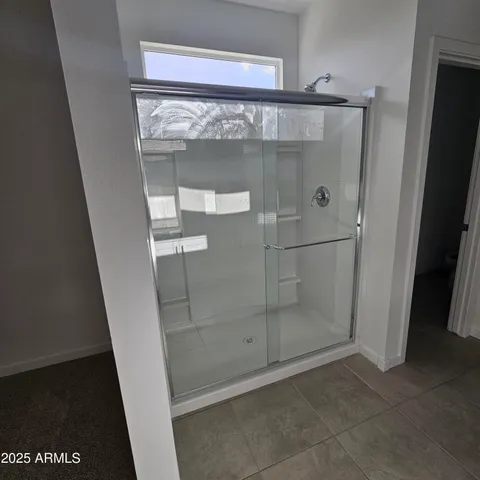 a bathroom with a glass shower door
