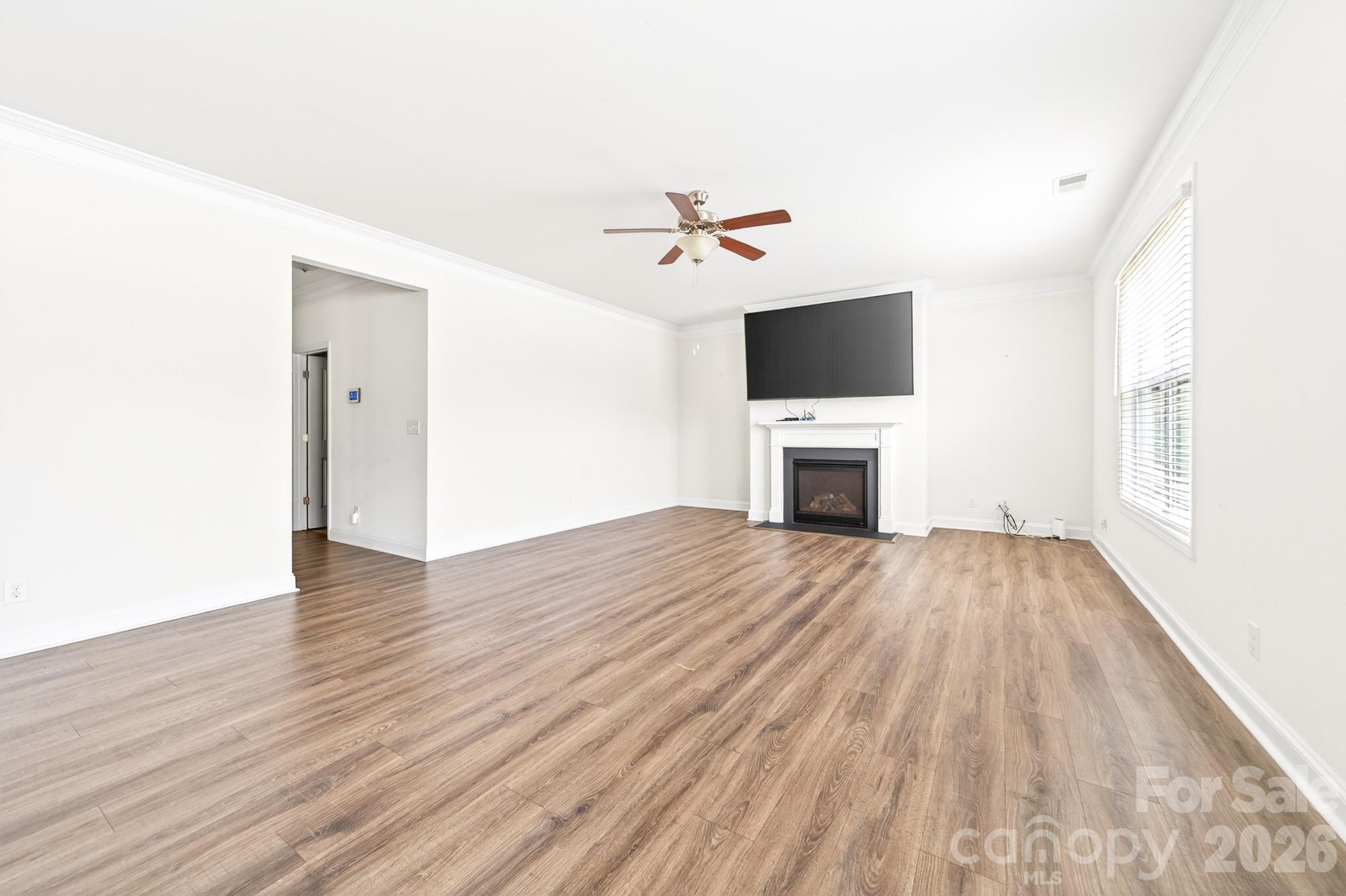 5972 Redwood Pine Road Concord, NC 28027 - Photo 16 of 37 wooden floor in an empty room with a fireplace